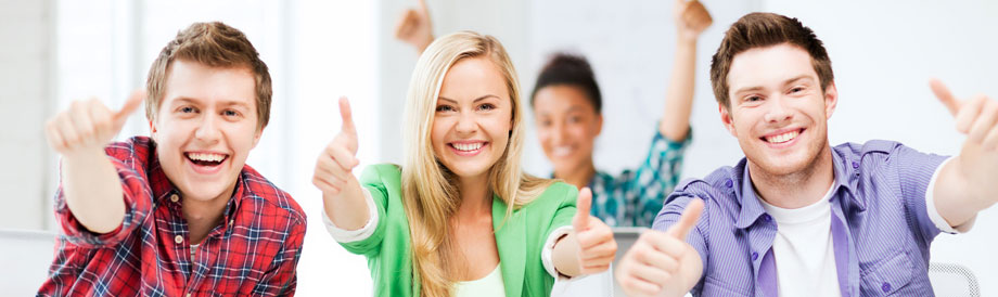 Happy students giving thumbs-up gesture